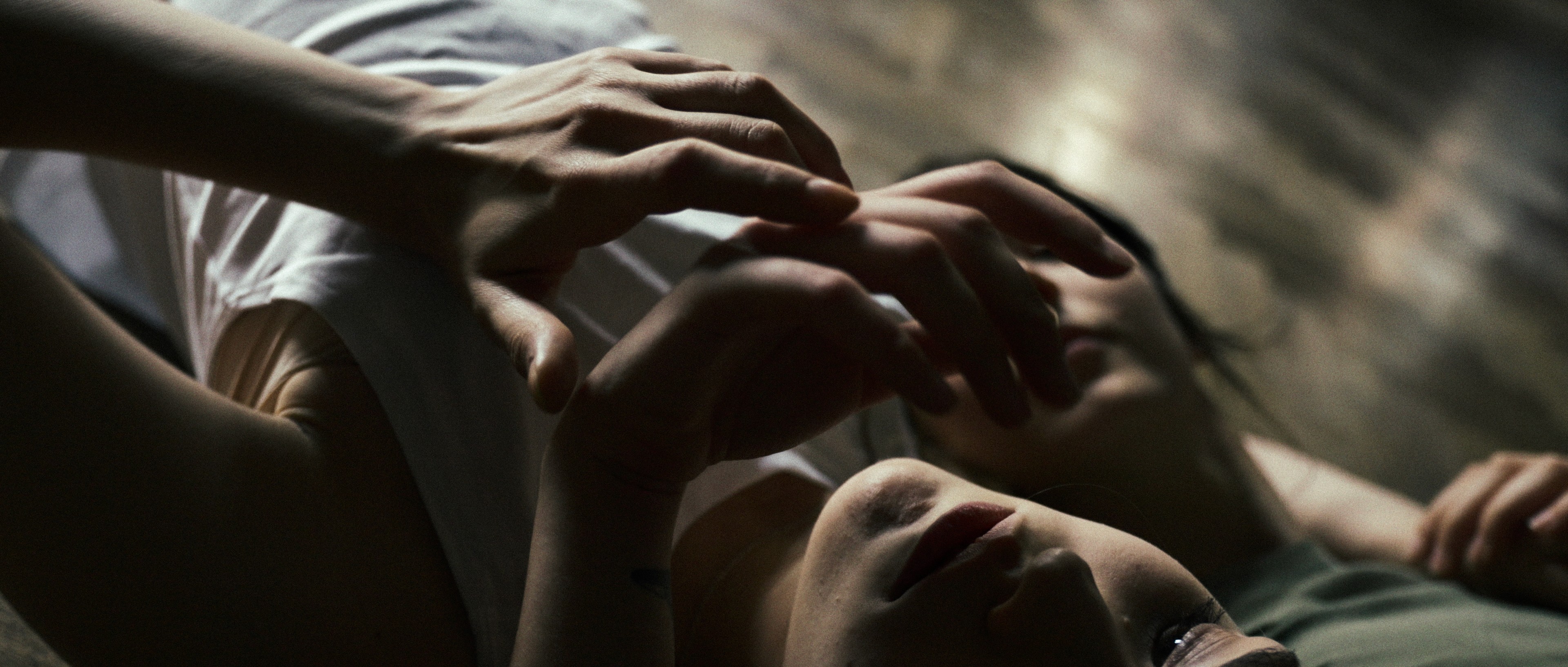Intimate close-up of hands touching a face, emotional scene in a narrative commercial.