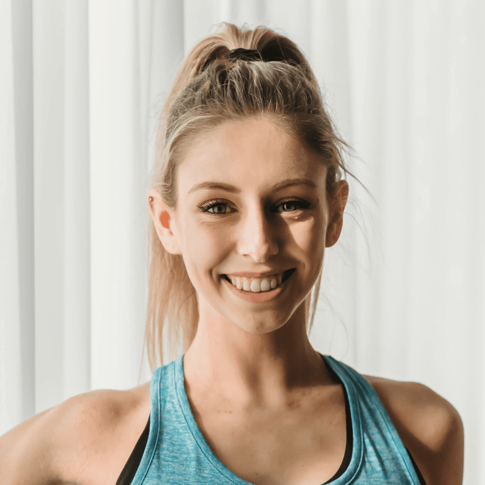 smiling woman wearing white and black pinstriped collared top