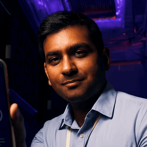 man in gray polo shirt smiling