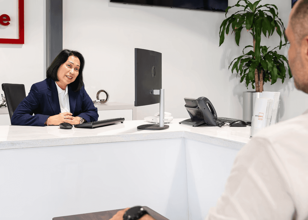 Staff assisting a client at a reception desk for Dubai business storage.