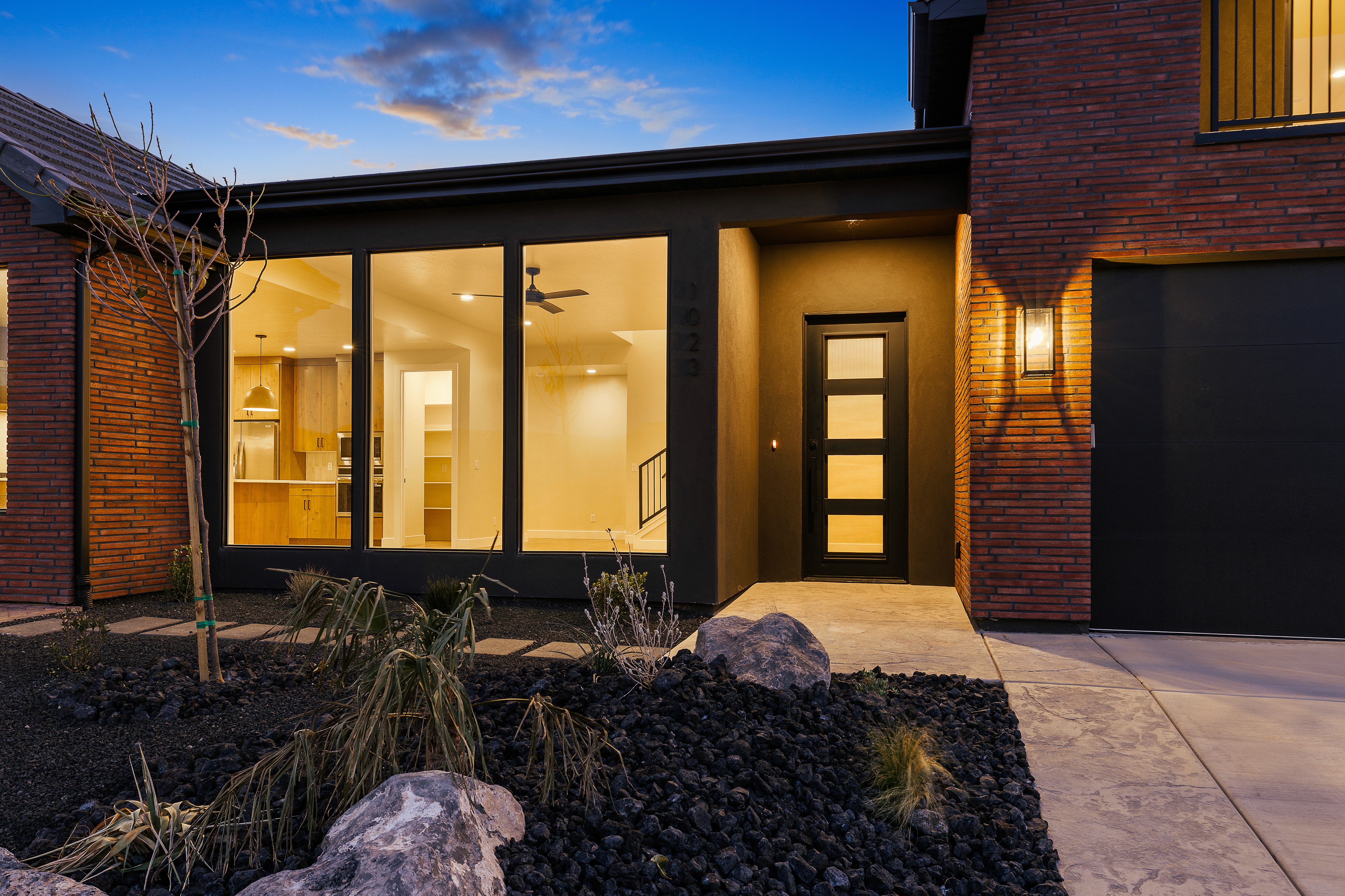 Night exterior of a custom home in Hurricane Utah with illuminated entry and garage