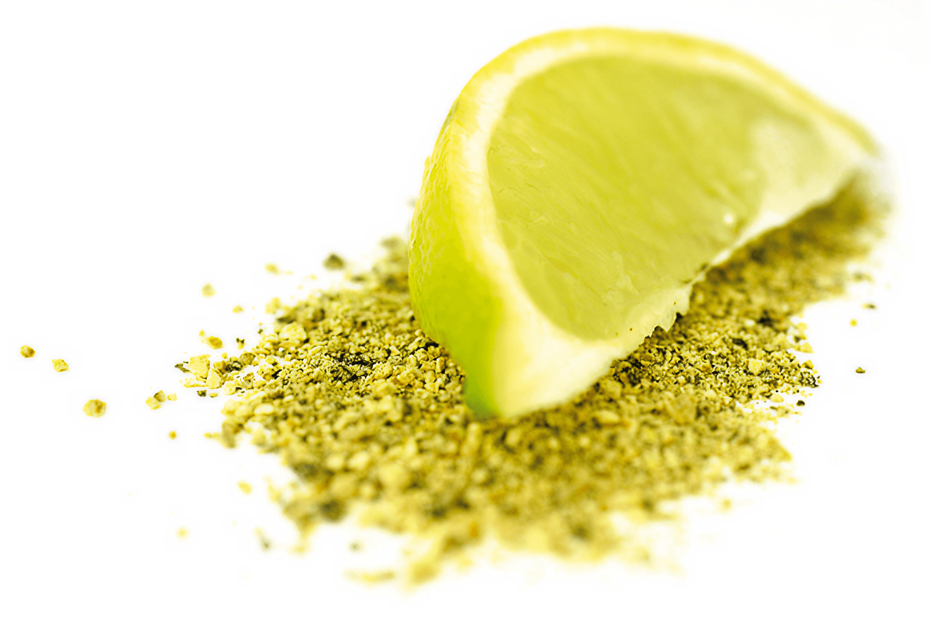 Lemon wedge on crumbled green spice blend.