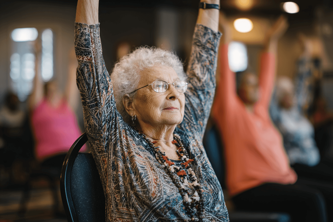 an elderly lady doing chair yoga in an assisted living facility.