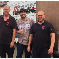 man stood next to open doors of a delivery van