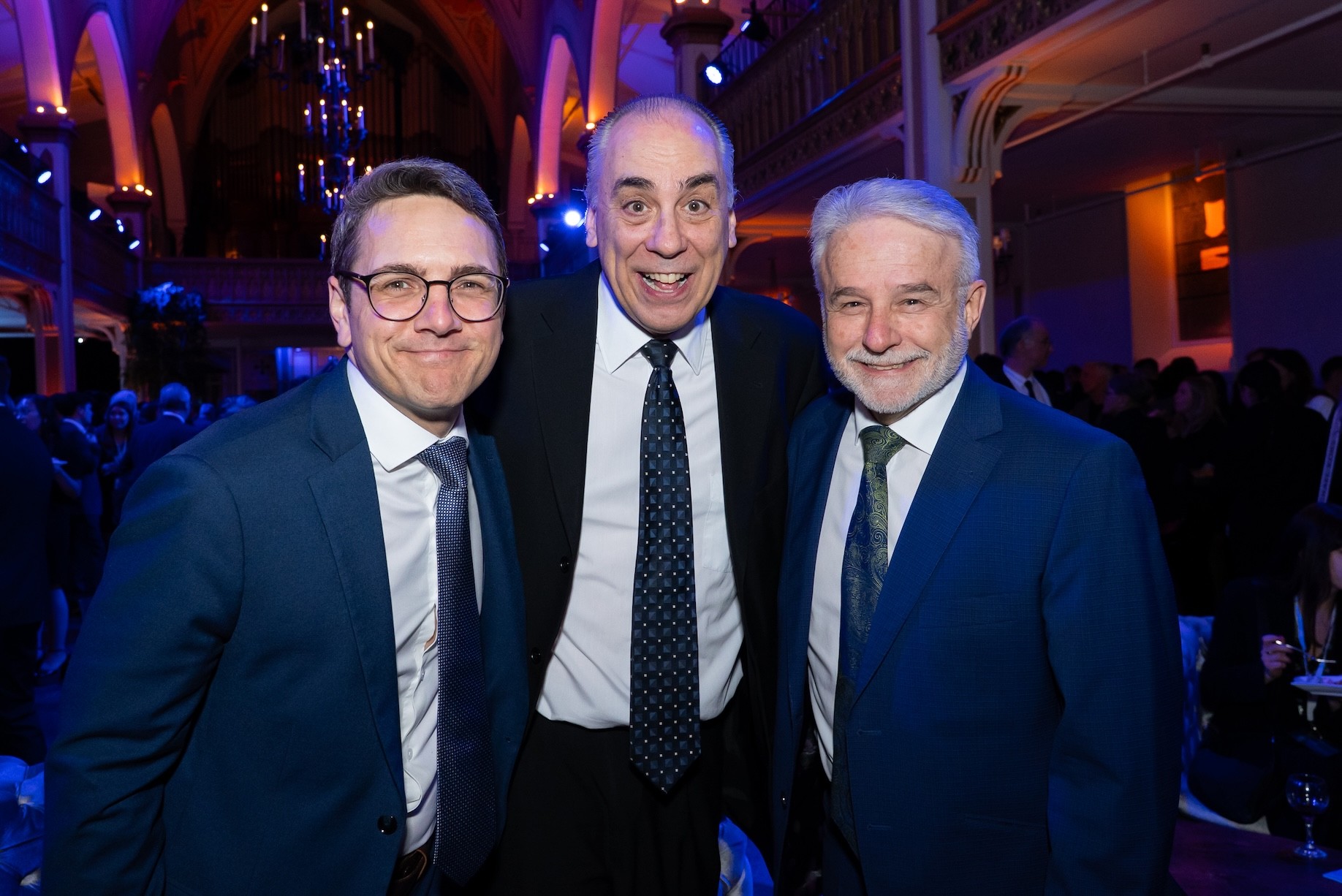 Corporate event photography of three men at Éducaloi anniversary celebration in Montreal