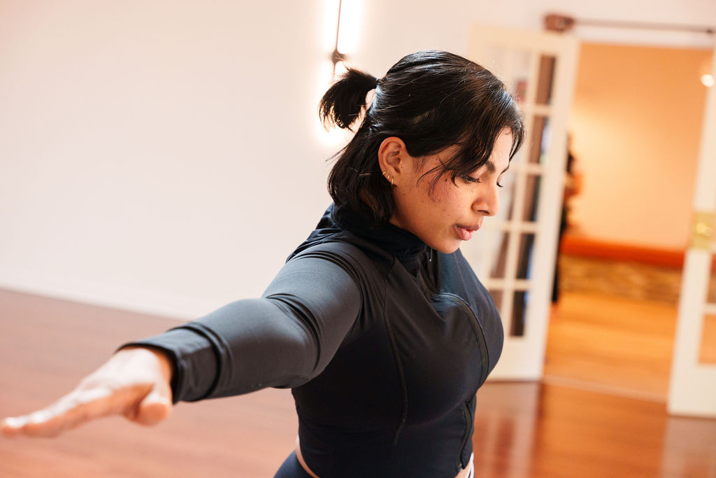 Woman doing Yoga poses in a Hot class in the West End of Toronto