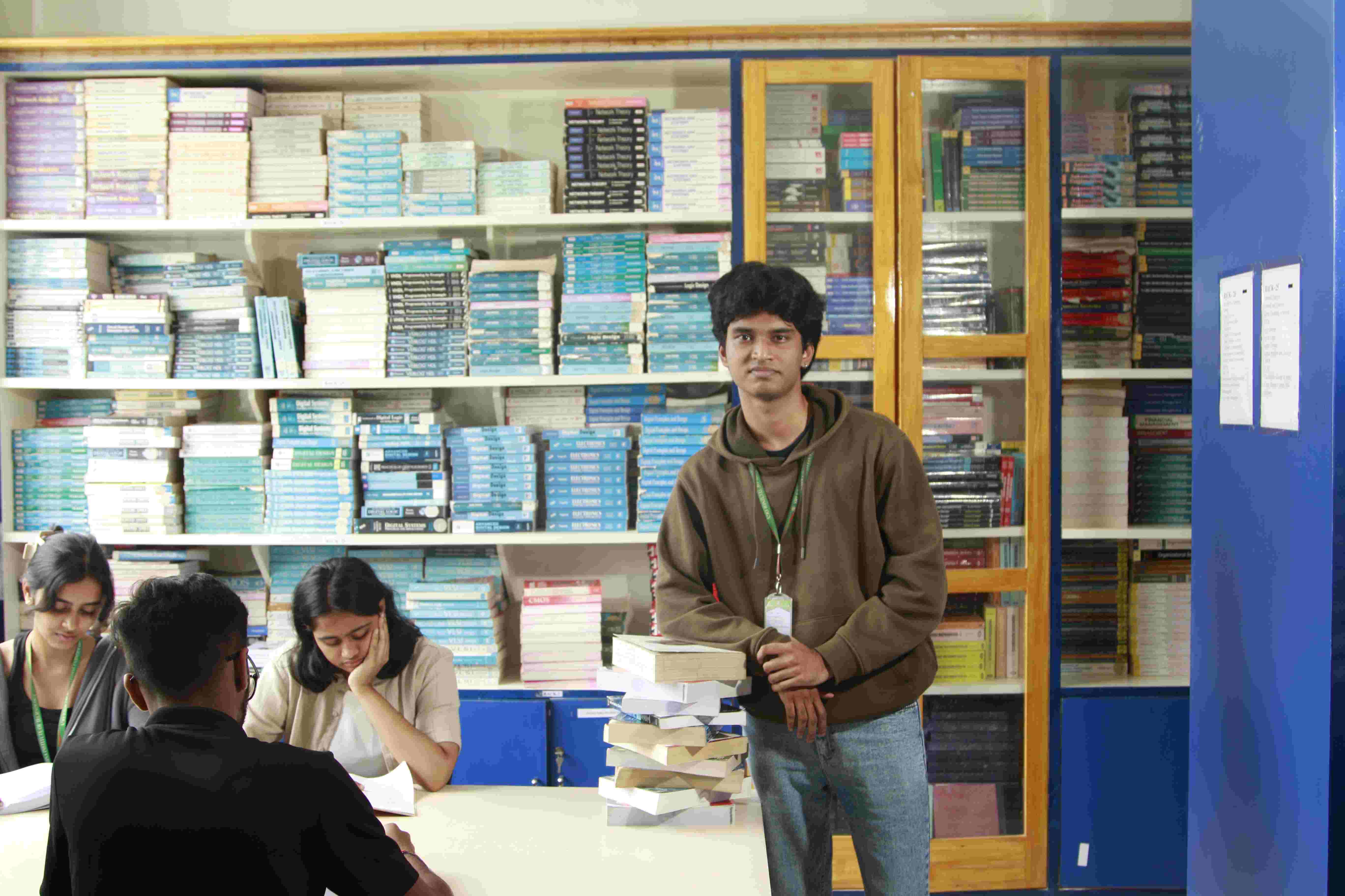 Students collaborating in a library and lab setting at a top private engineering college in India.