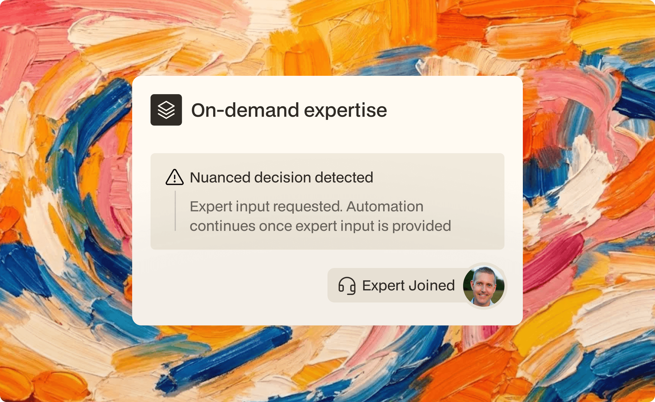 Young man in a green hoodie holding a yellow phone while seated at a table with a tablet.