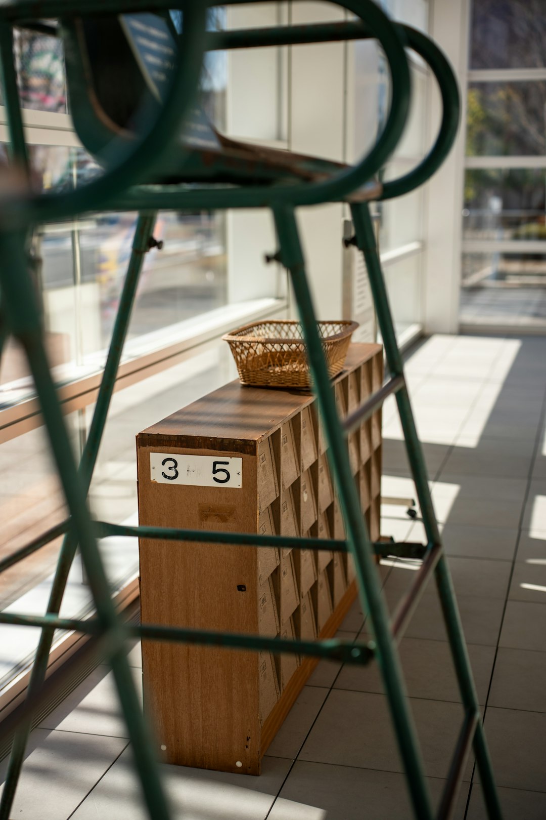 Wooden cubby shelf with numbers and basket.