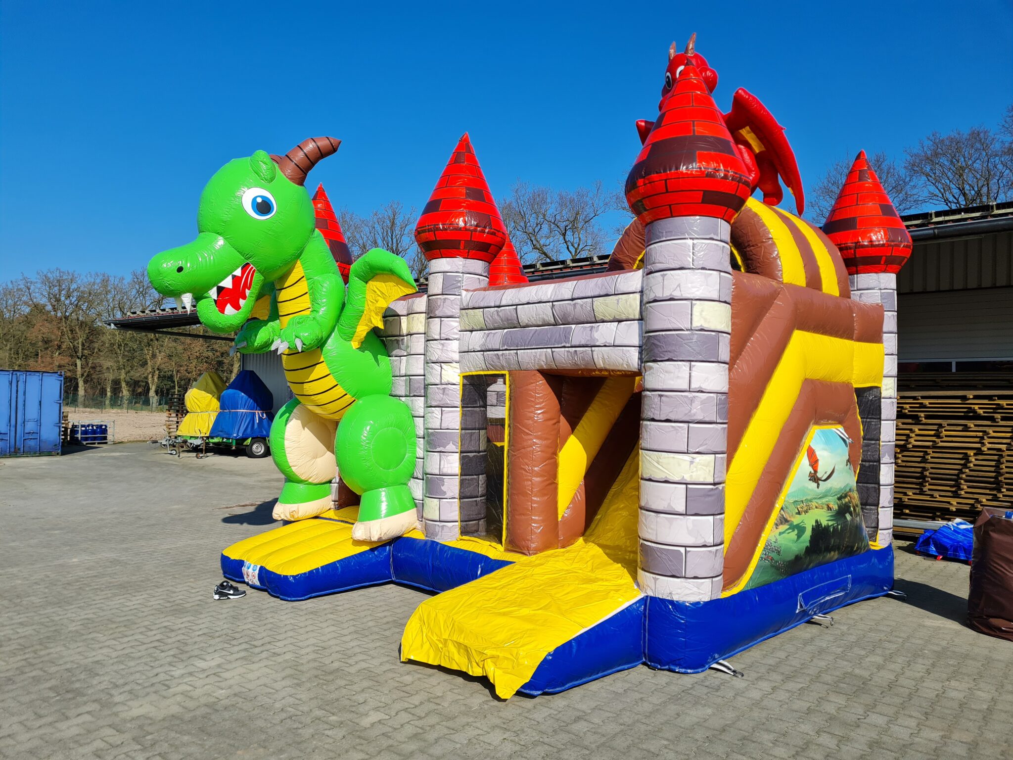 a storage building with red doors and a sky background