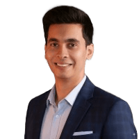 man sitting facing silver MacBook inside room