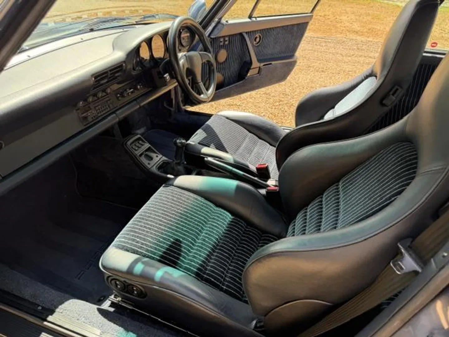 Interior detail of the pinstripe cloth sport seats and manual shifter