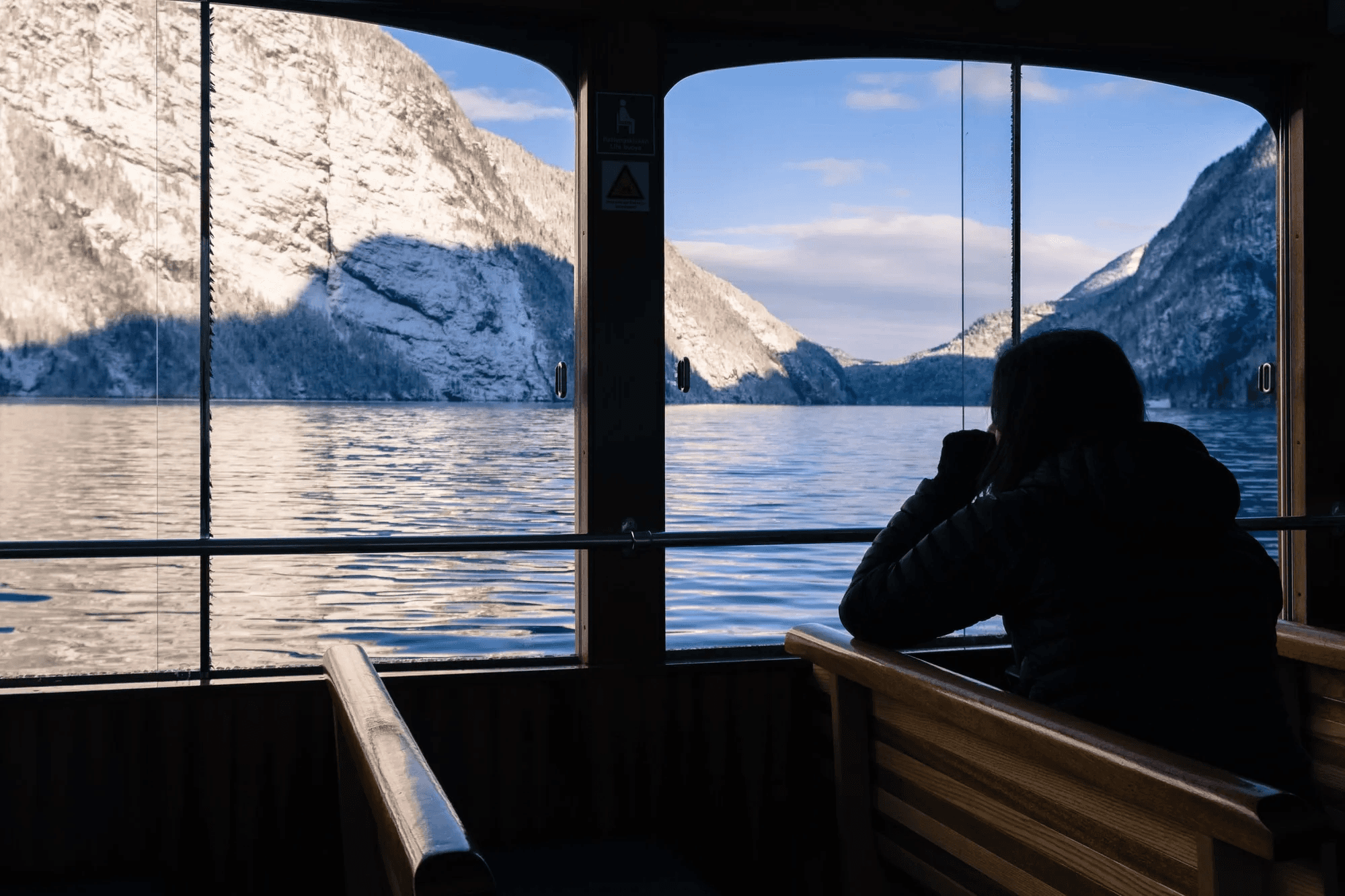 Woman on holiday admiring the Königssee in Germany from a boat.