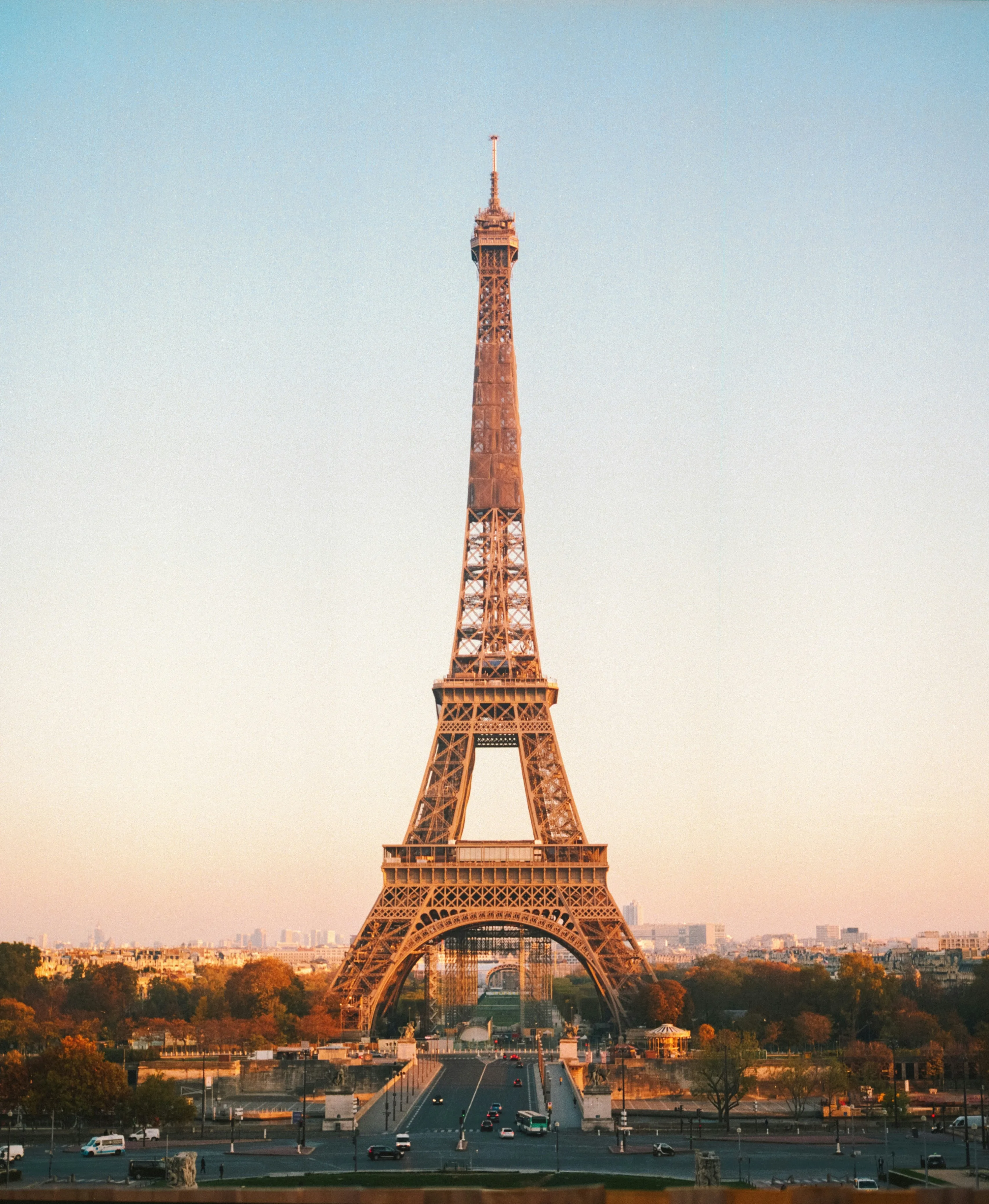 A photo of the Eiffel Tower at sunrise from the distance