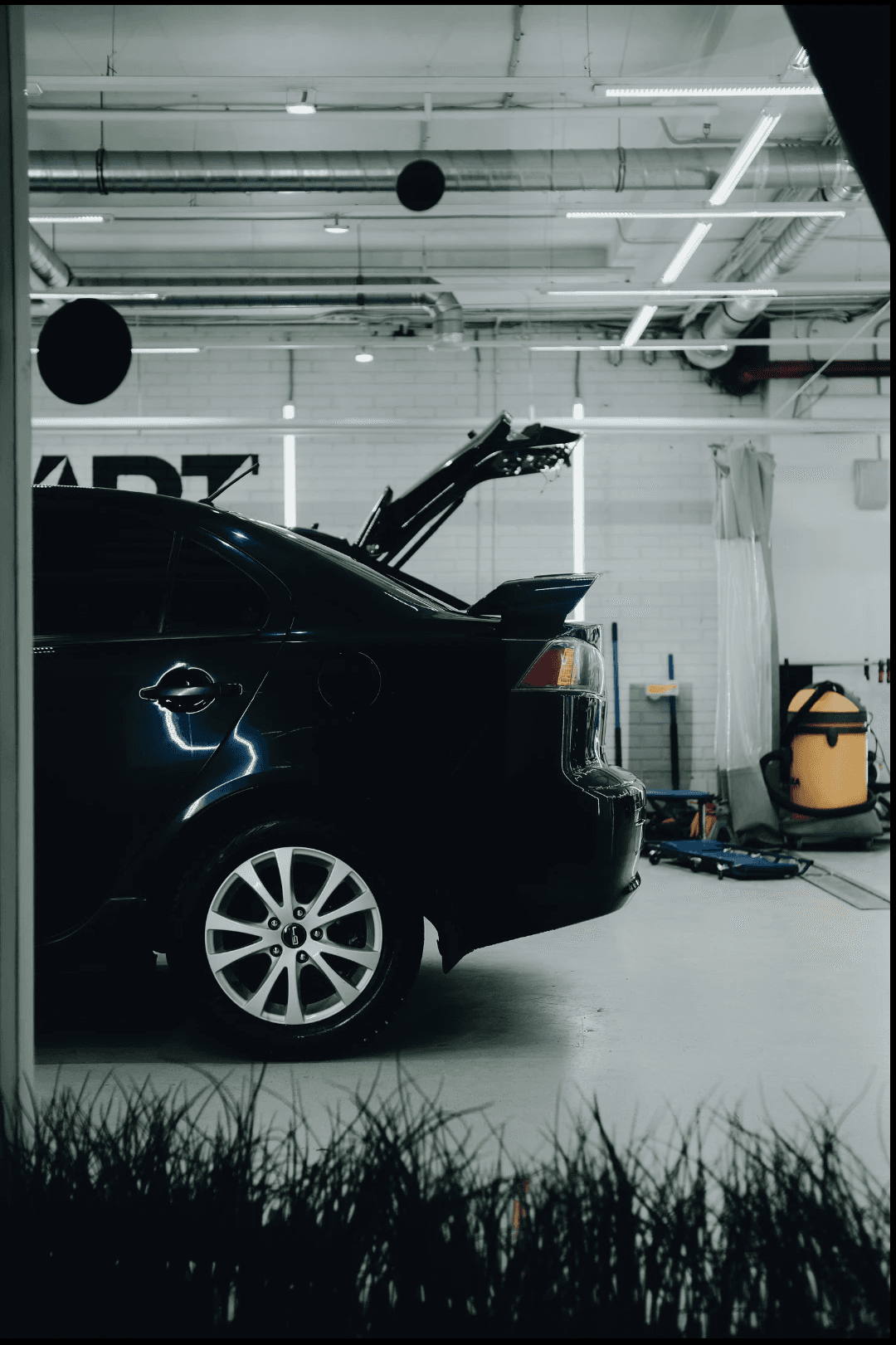 Collection of luxury sports cars displayed in modern rental showroom
