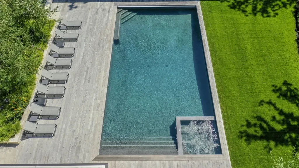 Automatic robotic pool cleaner maintaining a clean backyard swimming pool