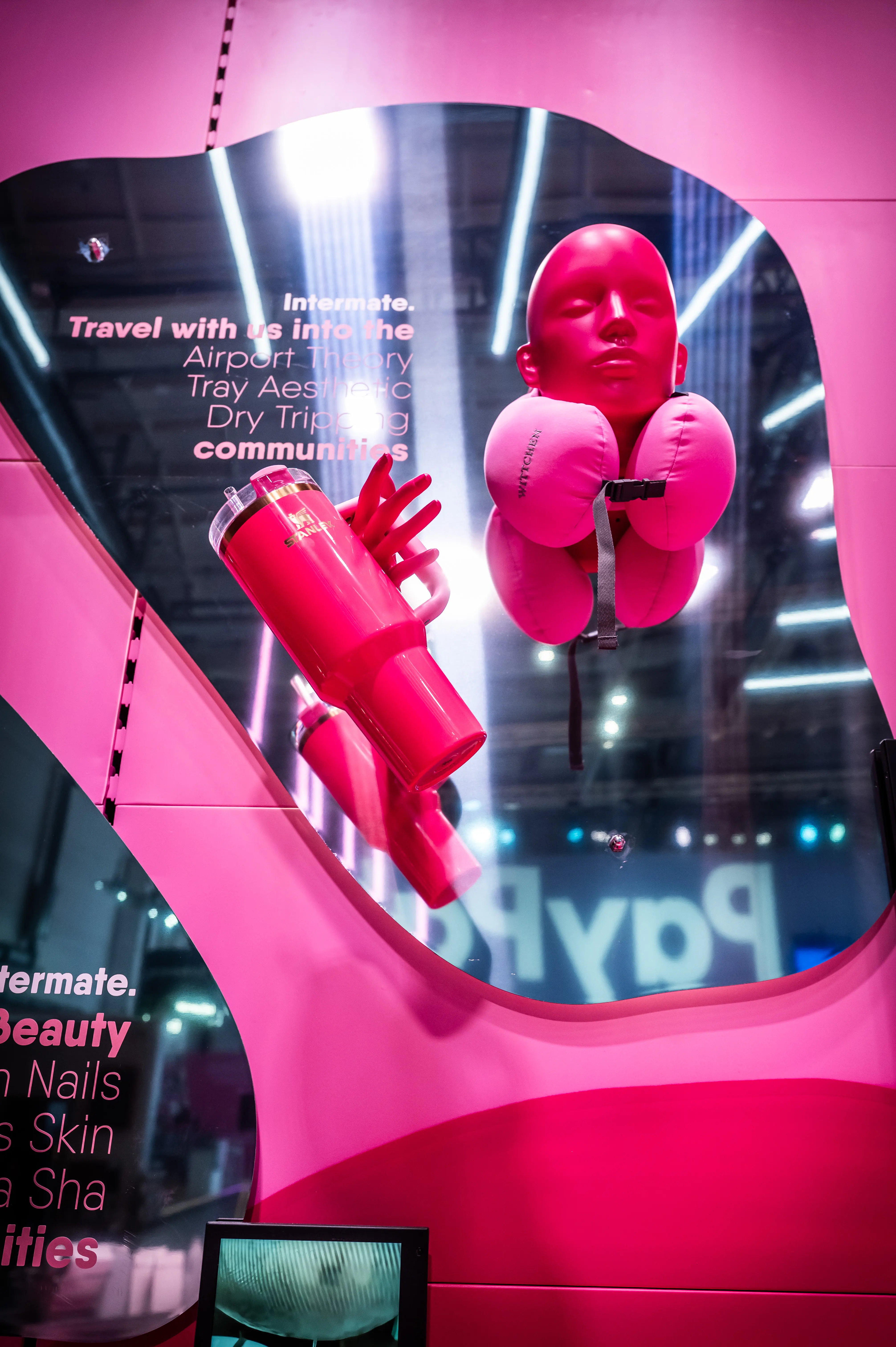 Travel-themed display with pink head, neck pillow and thermo mug at the Intermate Social Superstore at OMR.