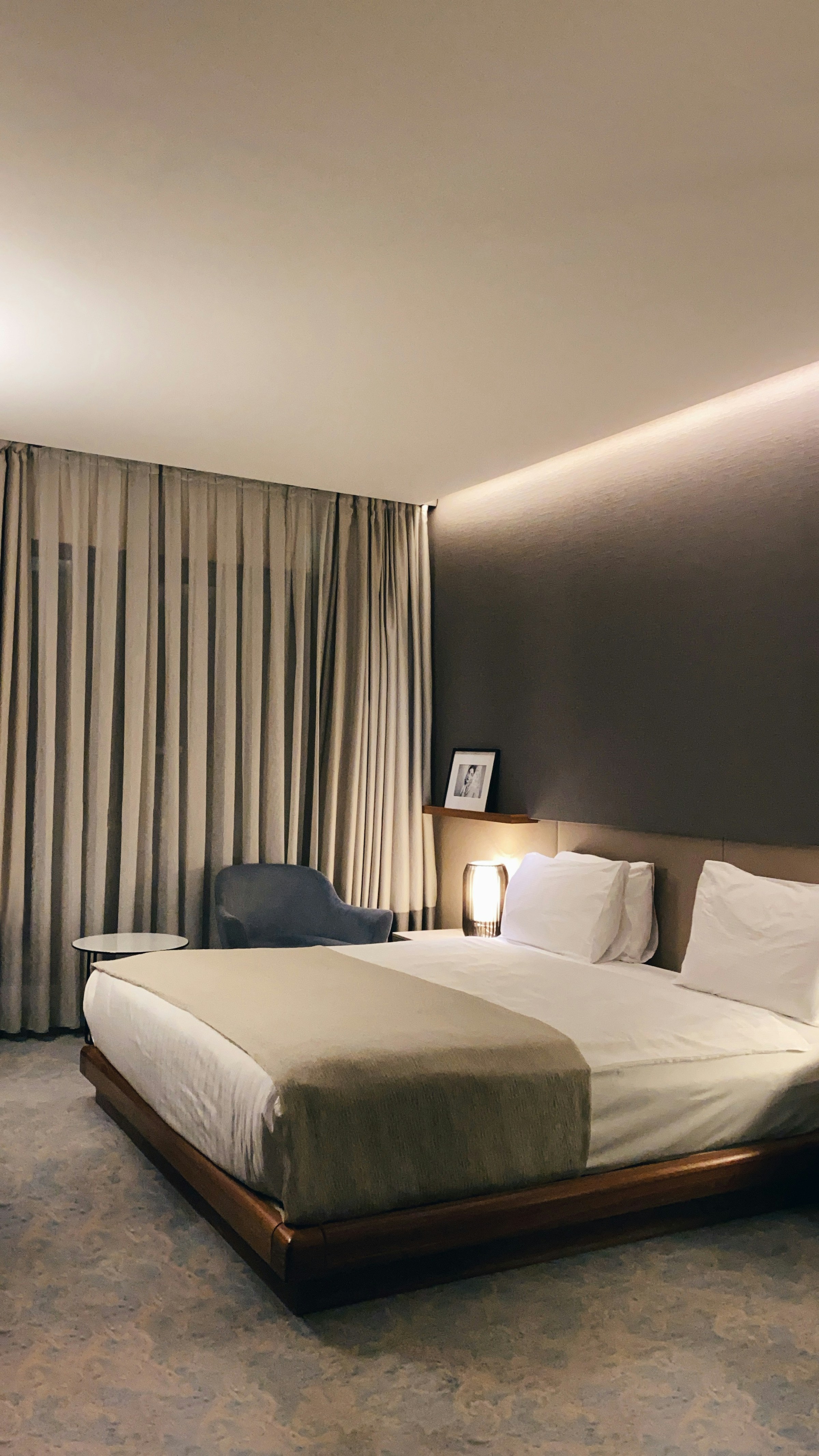 Calm hotel room with a low bed and curtains