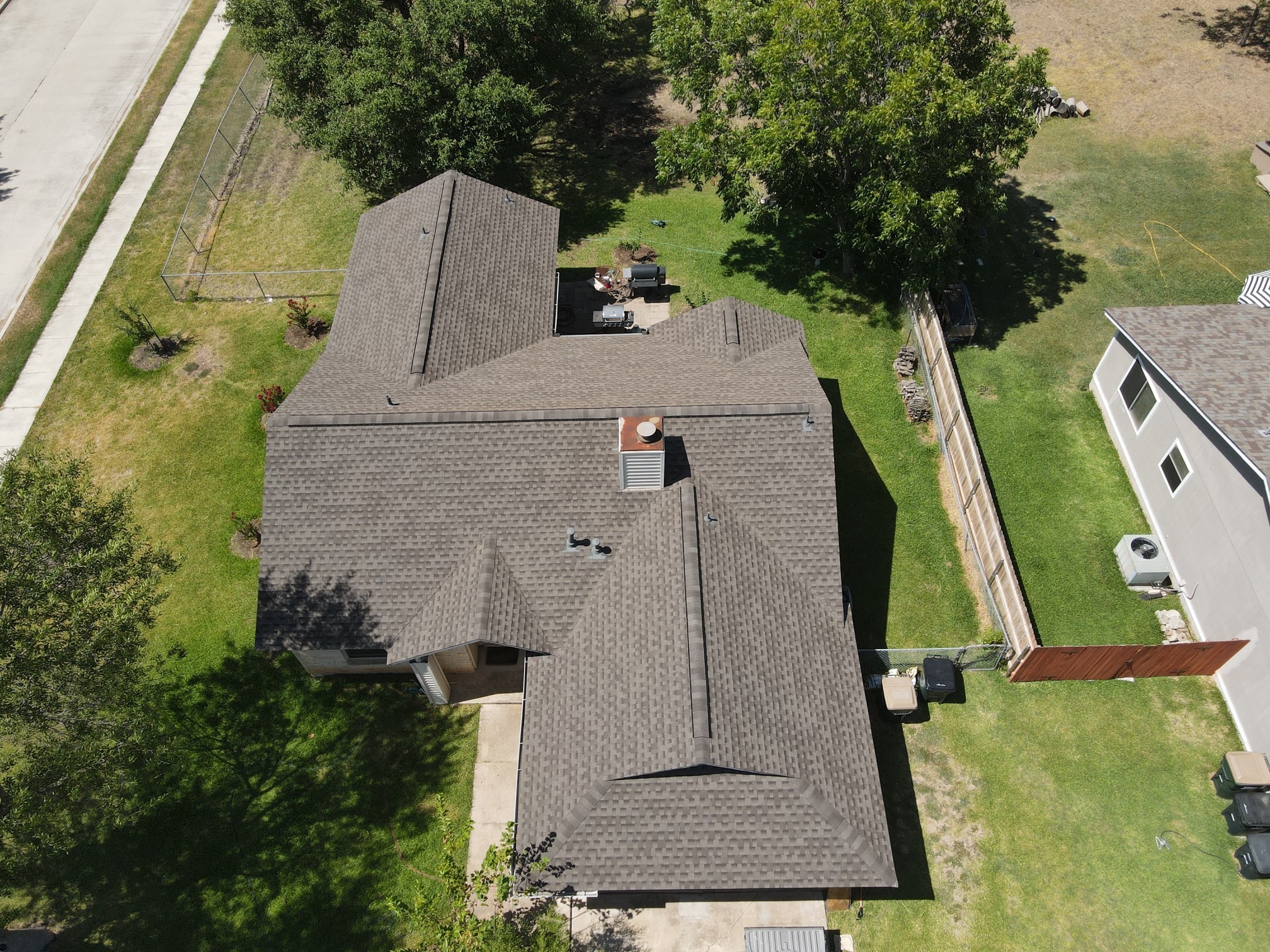 GAF architectural shingles with a ridge vent on a cross-hipped roof, offering a durable and well-ventilated roofing solution.