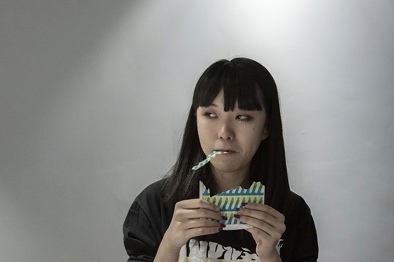 Miao Zhao eating printed paper