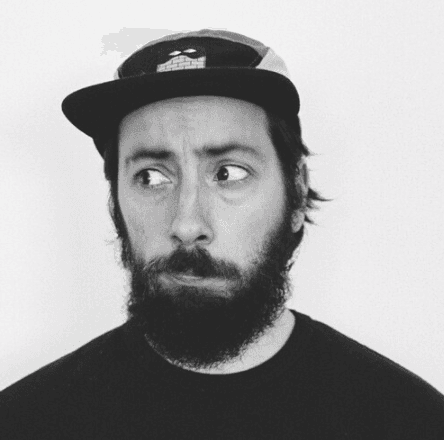 woman staring directly at camera near pink wall