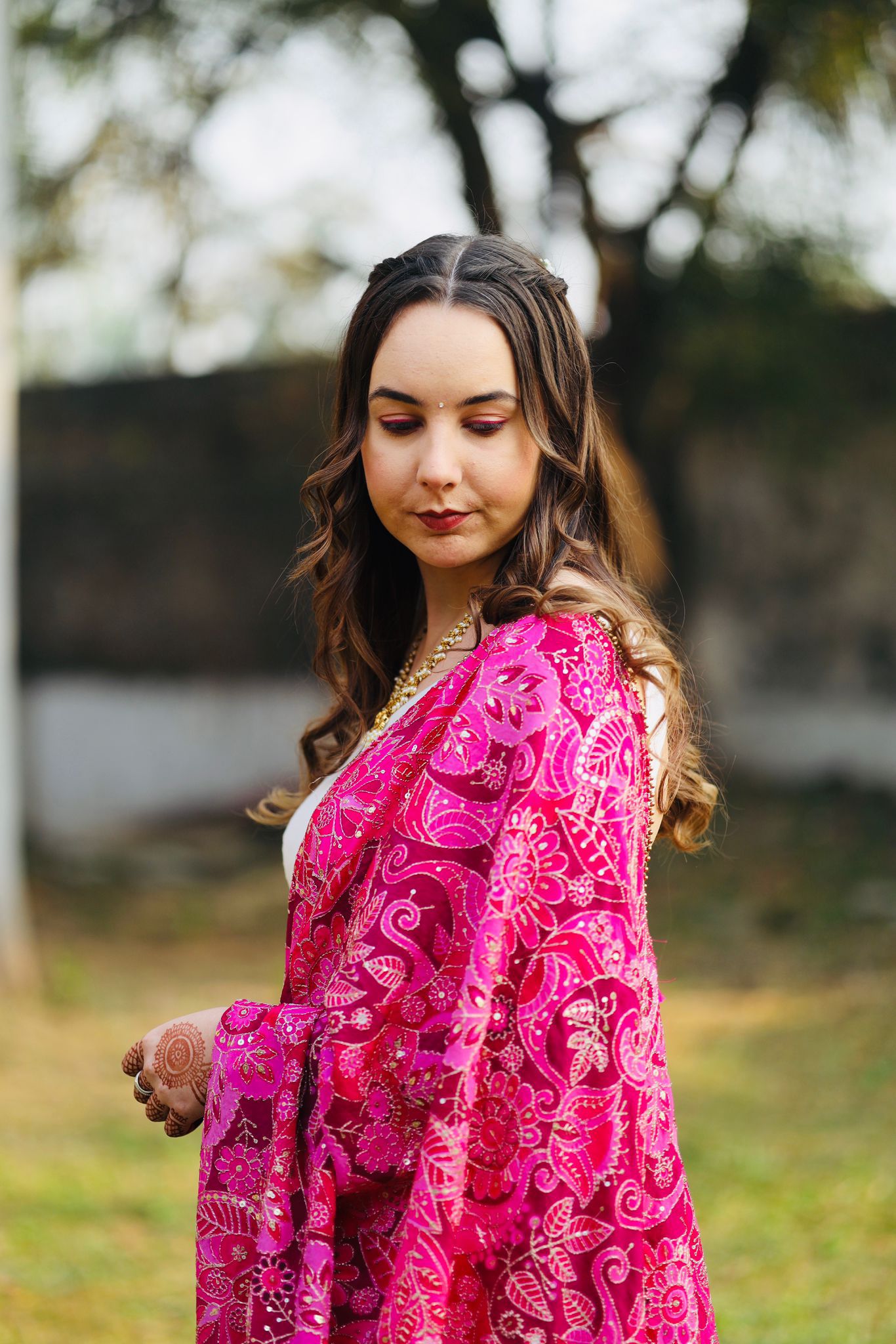 A girl with a beautiful smile stands at the reception in the Camelia beauty salon, awaiting visitors.