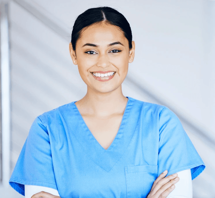 Elderly woman with white hair in blue patterned shirt.