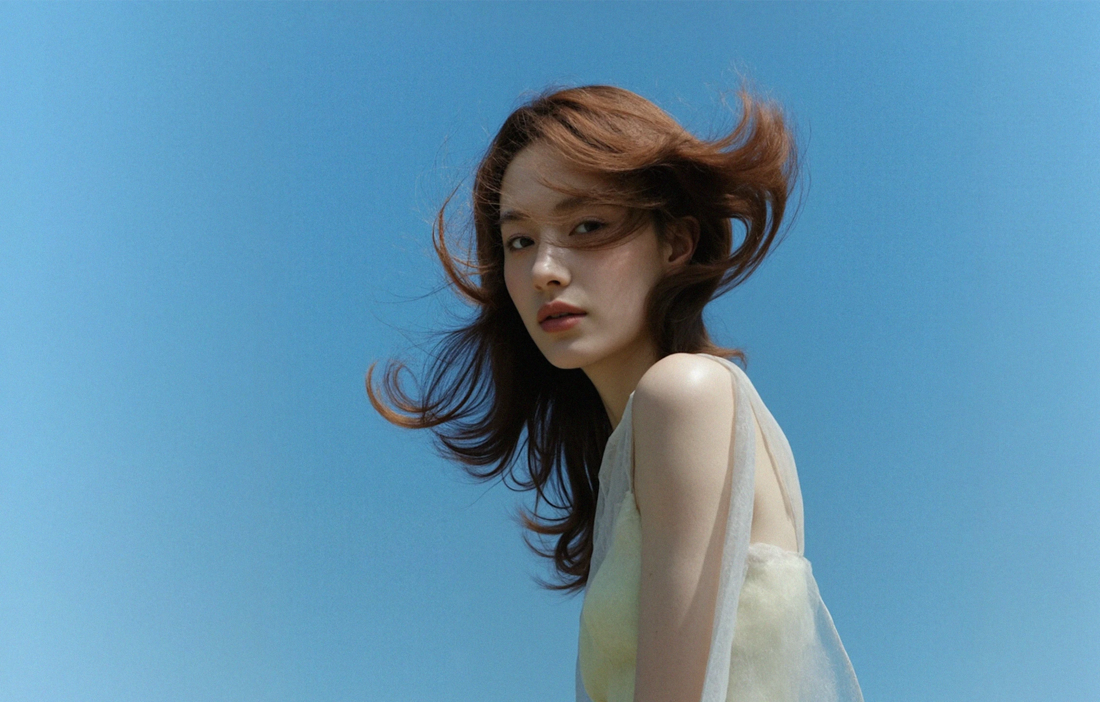 Portrait of a woman against a blue sky