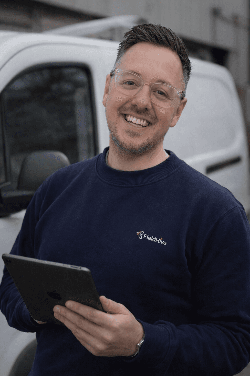 Daniel Sanders, founder of FieldHive, beside his van