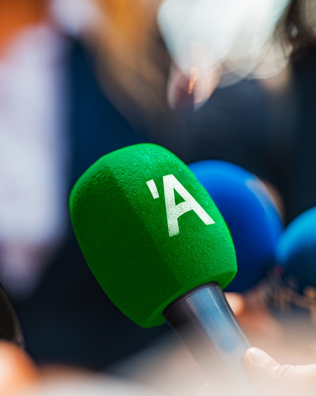 White outline of a classic smiley face followed by the text “Smiley Co” in white serif type on a vivid orange background.