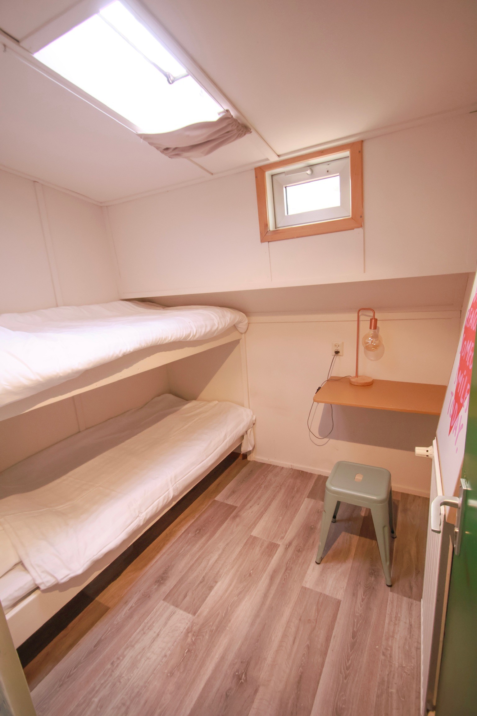 Grey marble bathroom with round mirror and floating sink