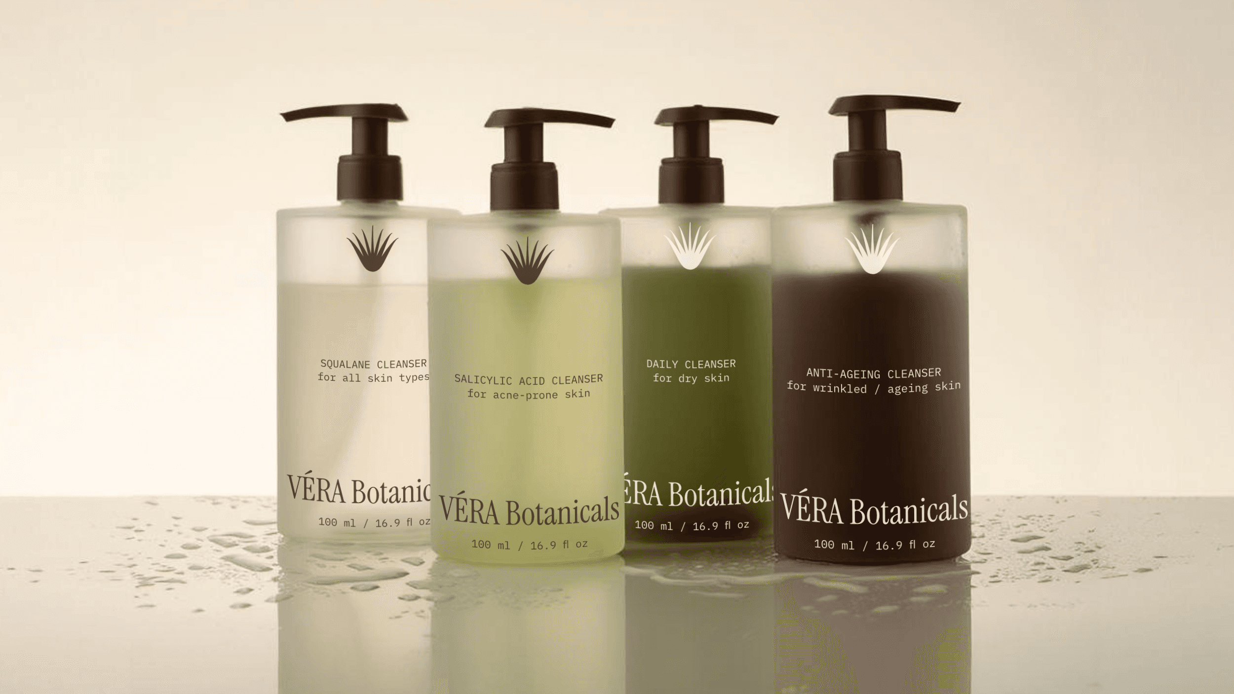 The packaging bottle designs for the organic skincare brand VÉRA Botanicals. The bottles feature a frosted glass finish with different colored liquid inside, ranging from off-white to green to brown.