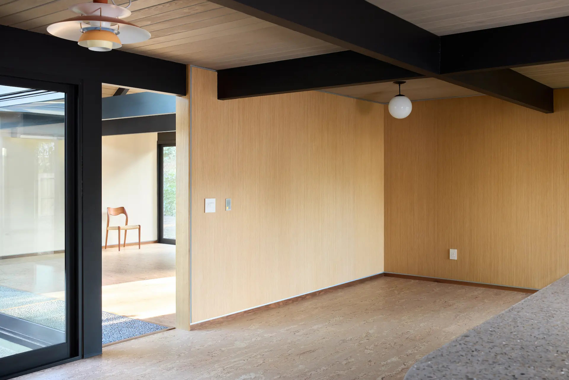 Angled view of the dining room, blending historical inspiration with modern luxuries in this Eichler home remodel. Photo by Todd Huge.
