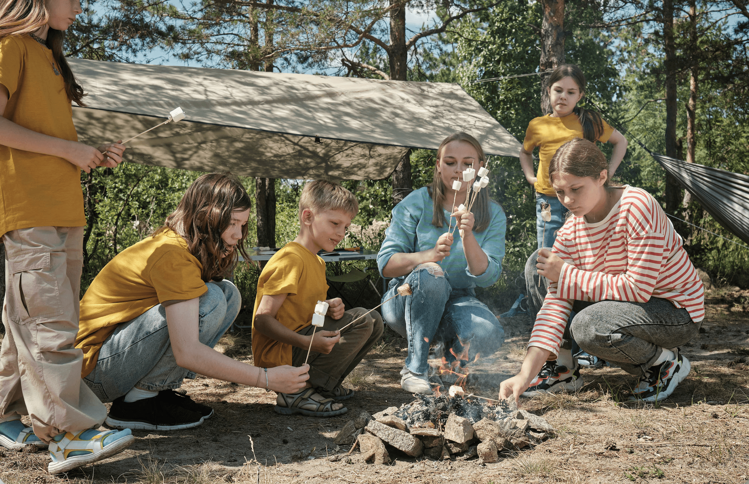 kids toasting marshmallows over a campfire