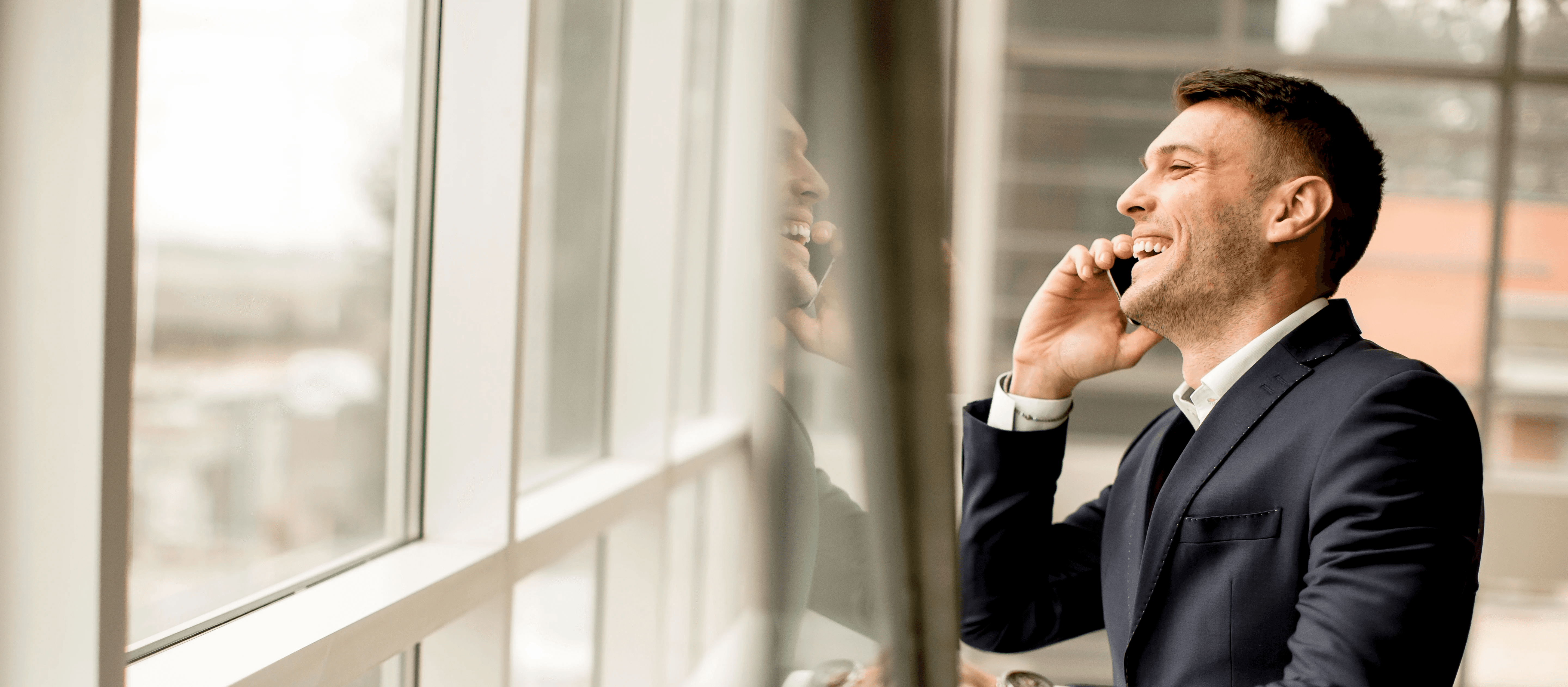 two people in a workspace working on their laptops 
