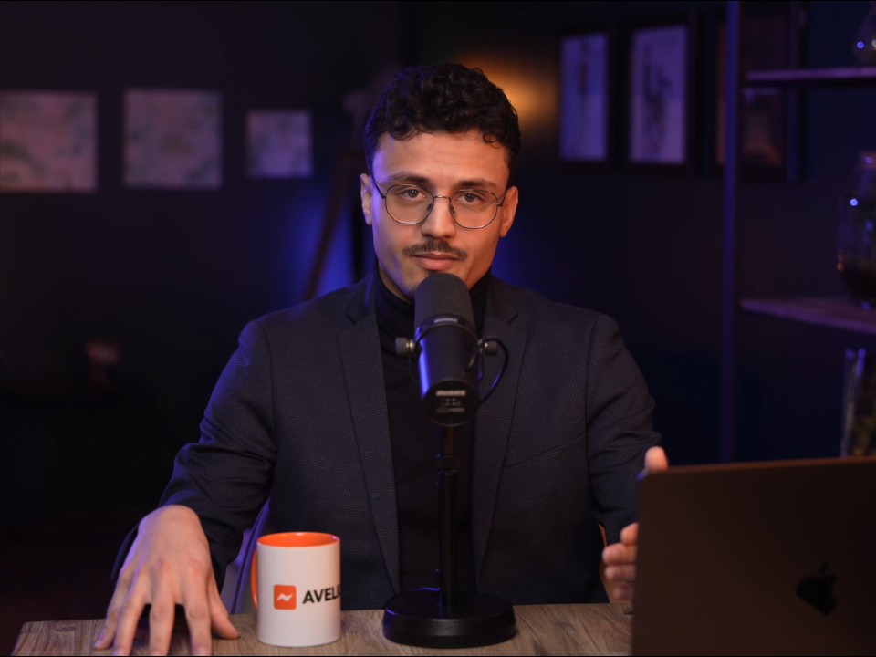 Man in blue shirt typing.