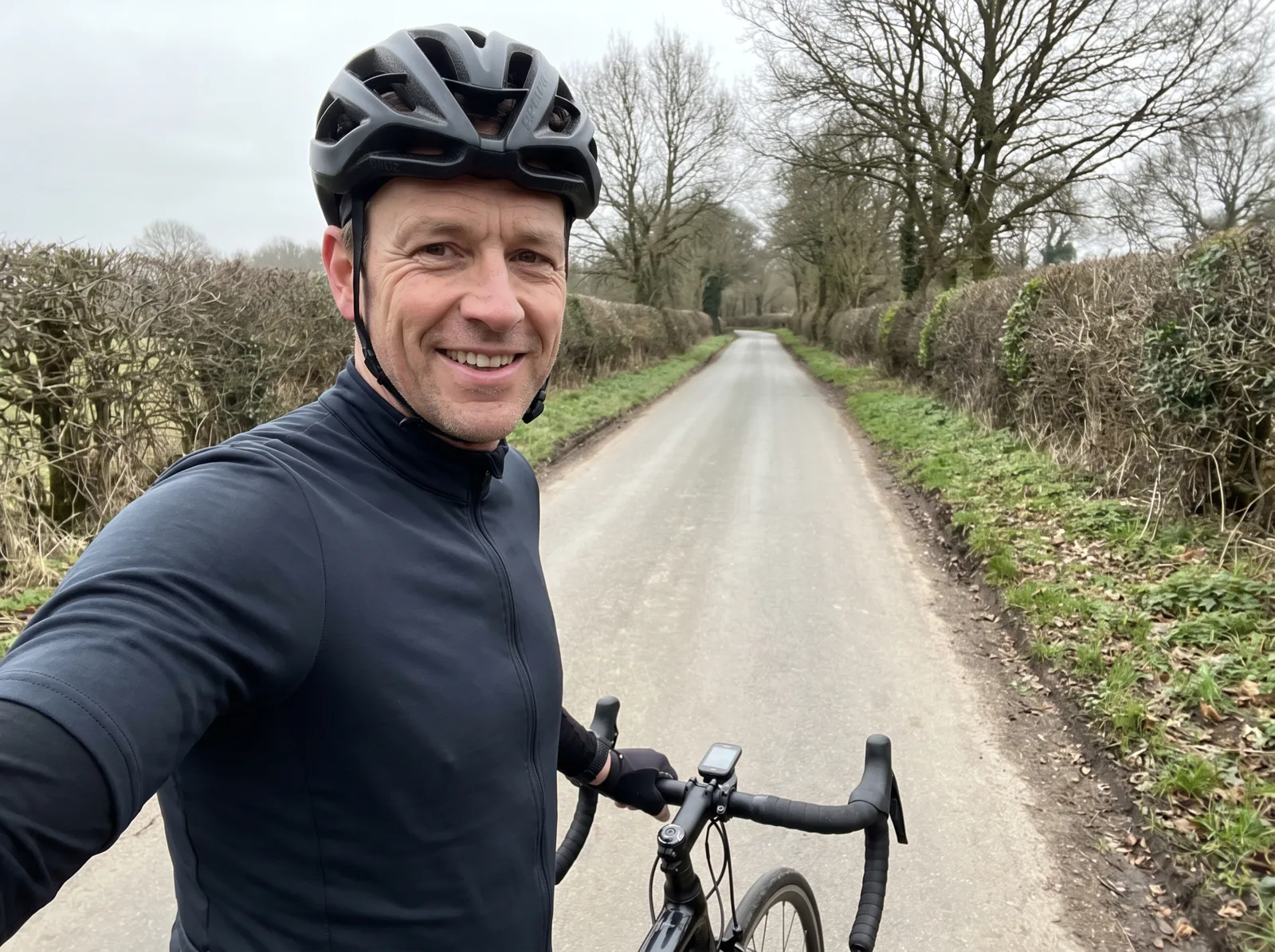 Dave with his road bike on a country lane