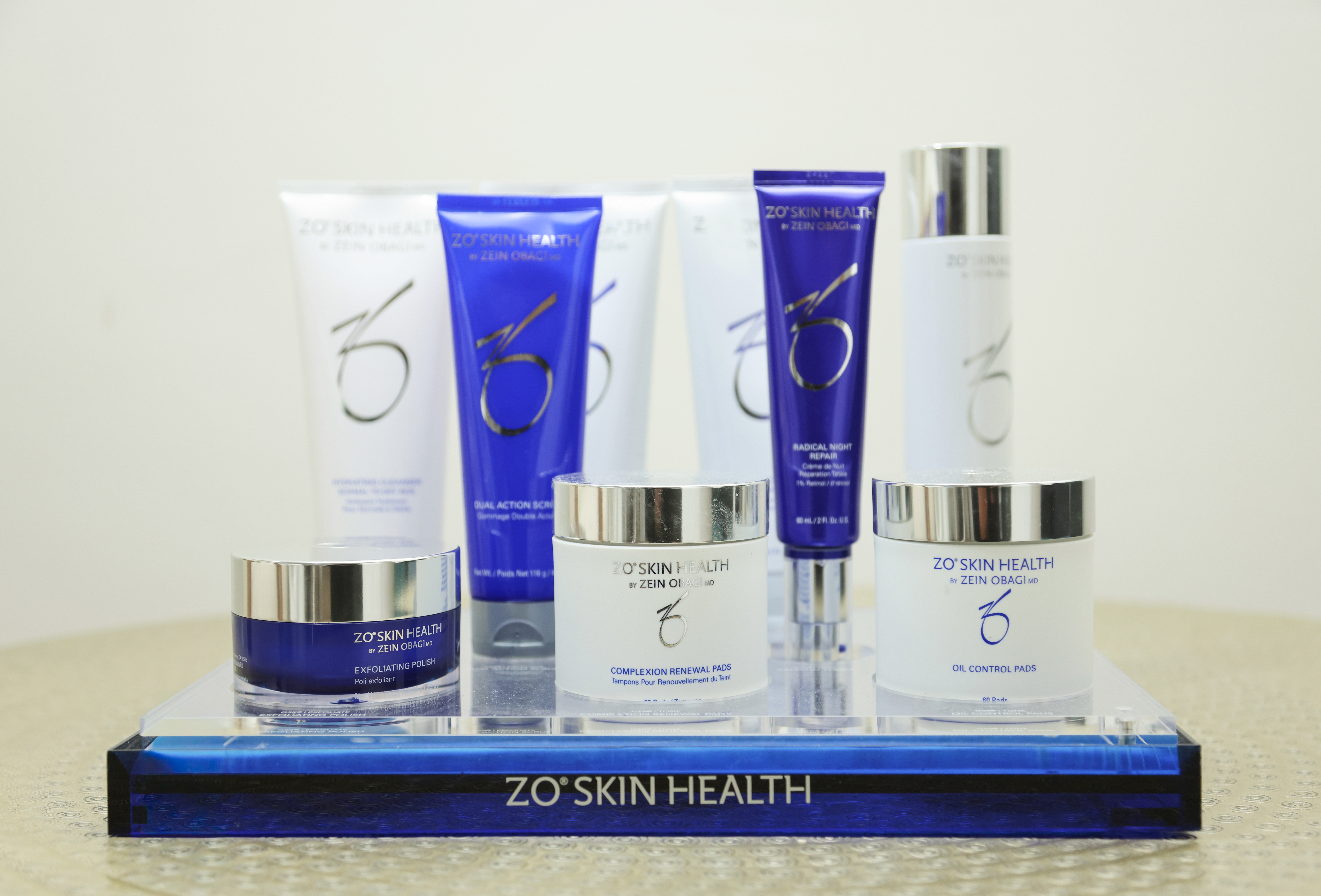 a woman in a blue dress holding a bottle of medicine