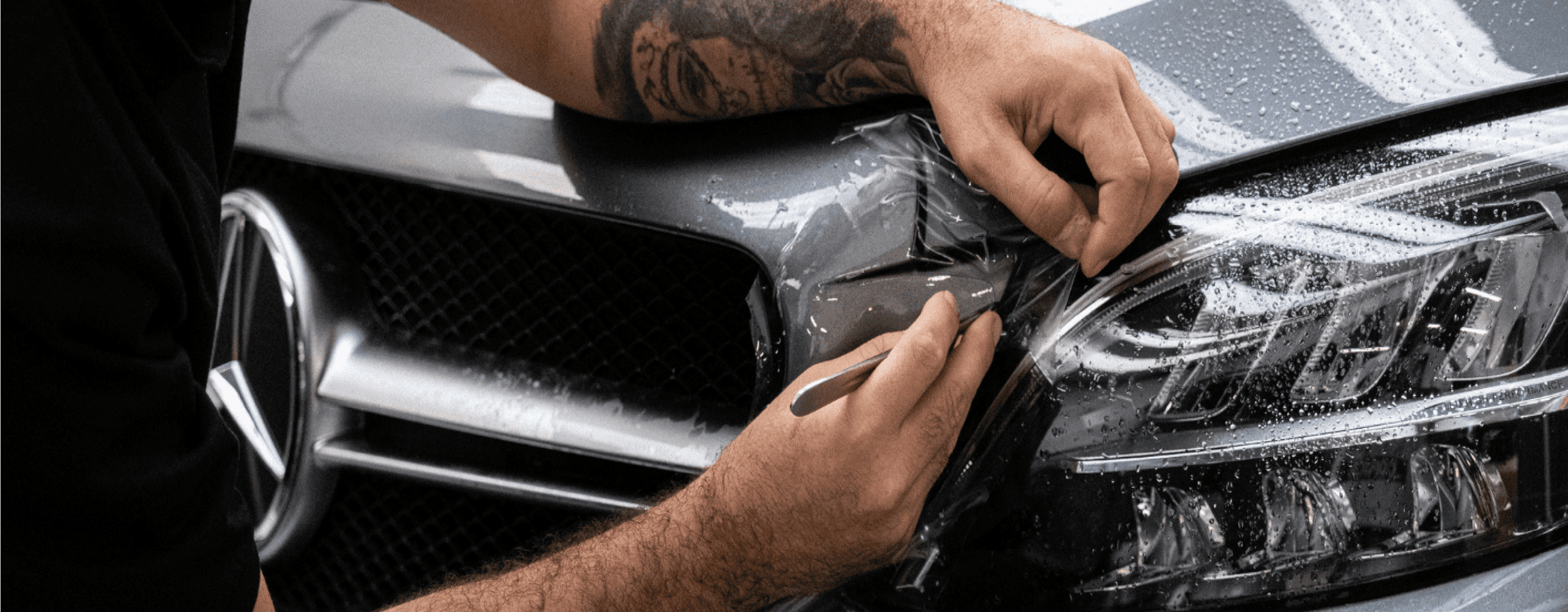 Detailer applying paint protection film
