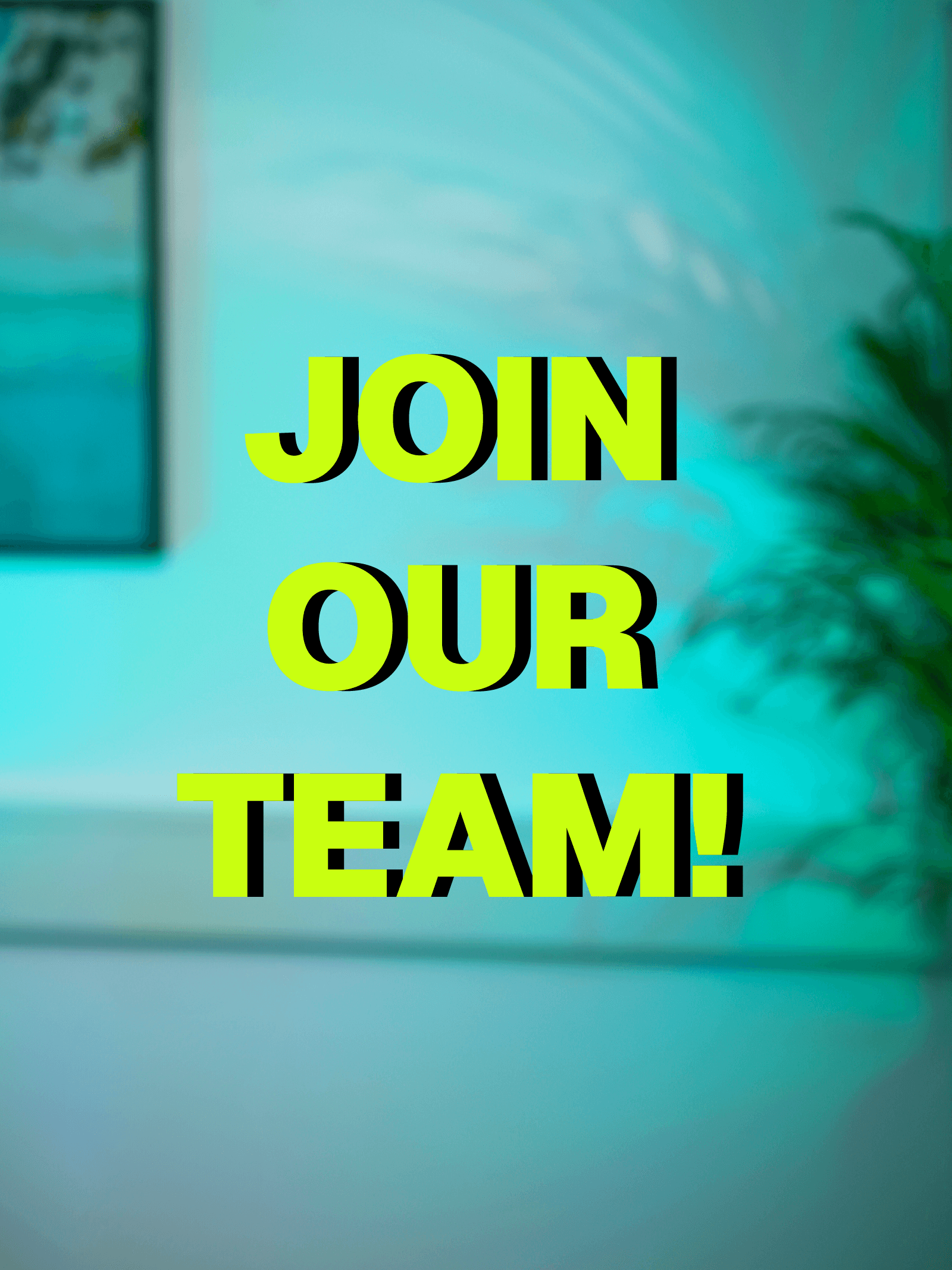 A woman with short curly hair wearing a black t-shirt looks into the camera.