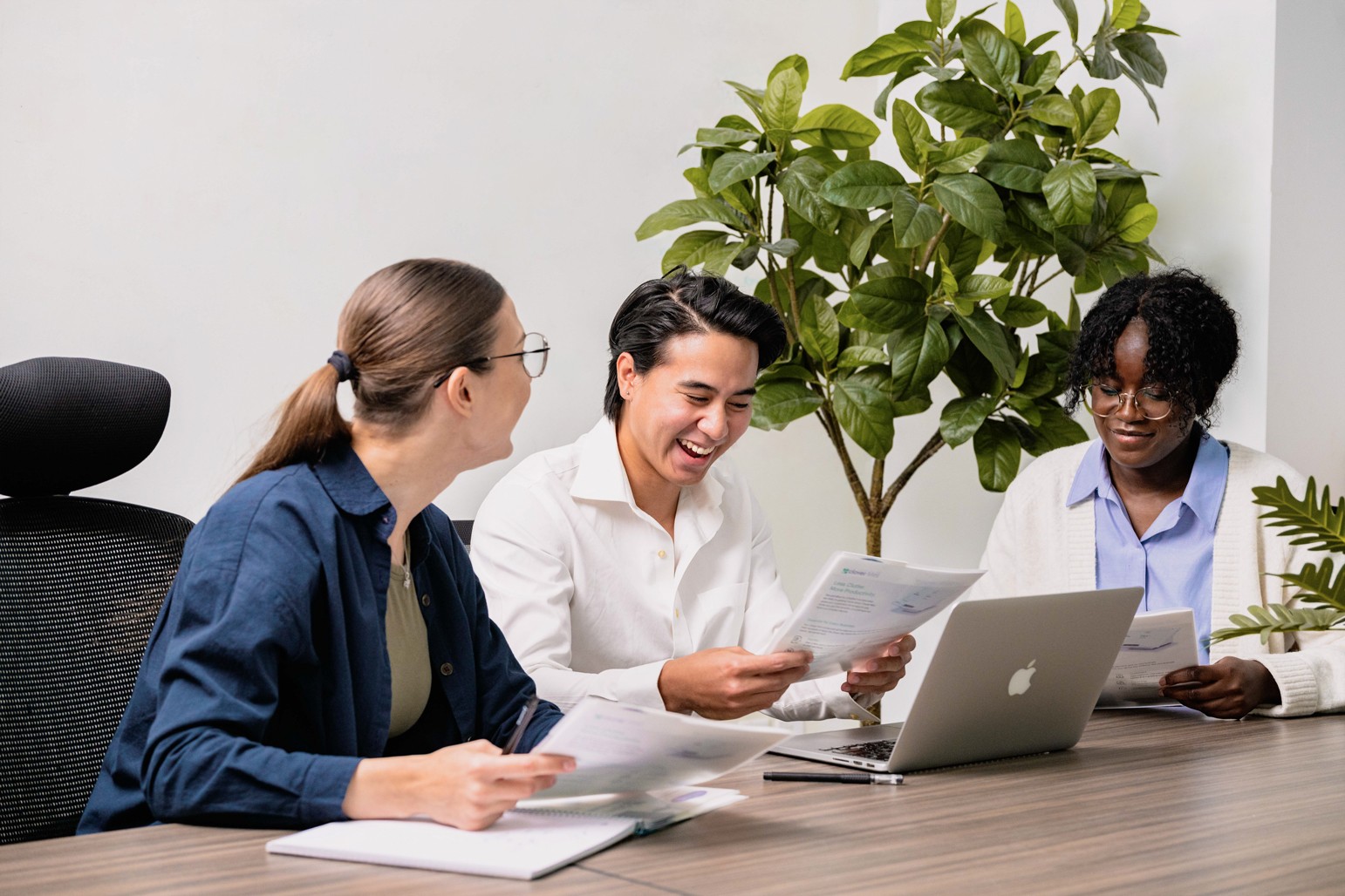 A photograph of Vandy Digital Marketing discussing a report with clients.