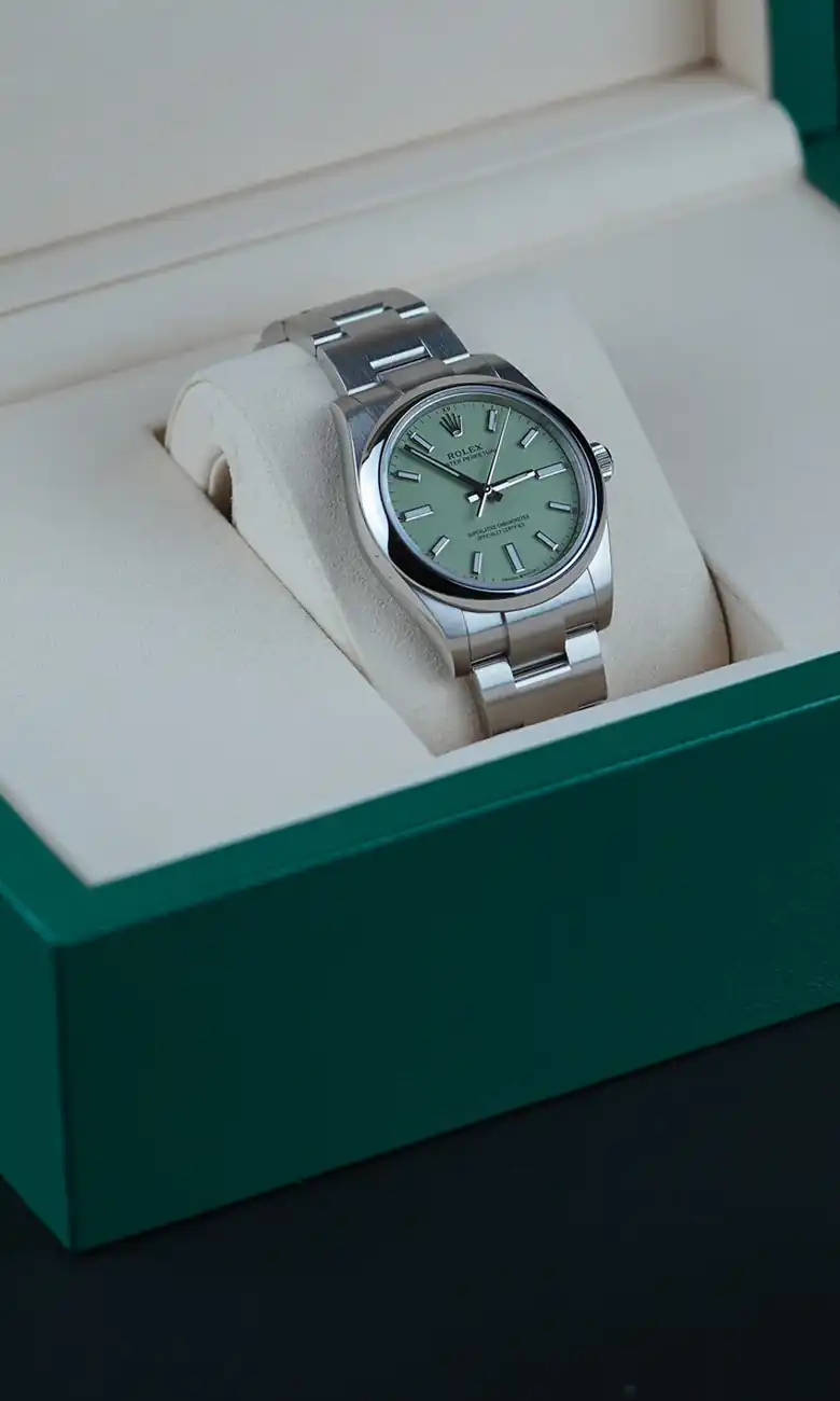 Rolex Oyster Perpetual with pistachio dial in its green Rolex box, valued at today’s Dubai market price