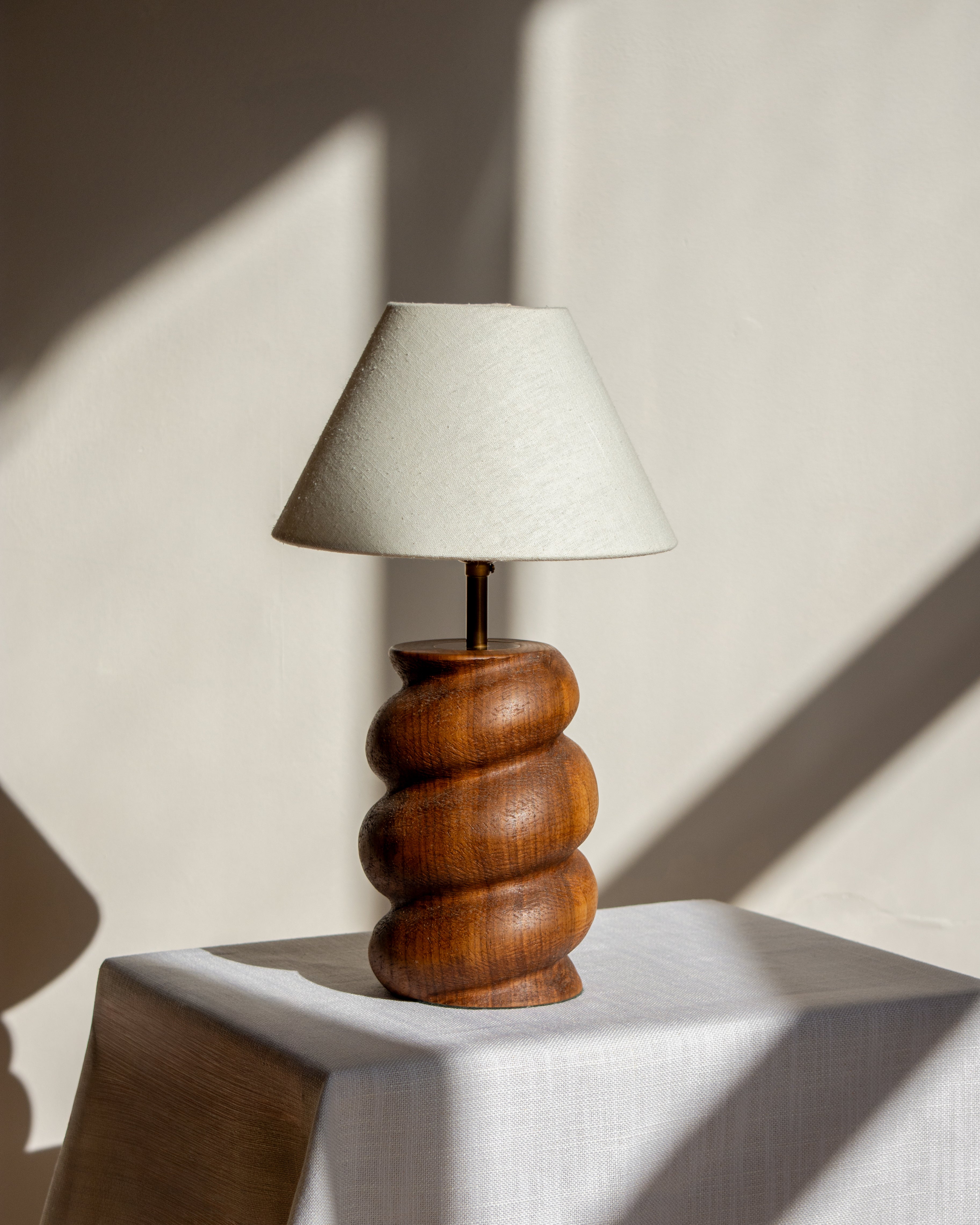 Caracol Table Lamp in Walnut on white linen table