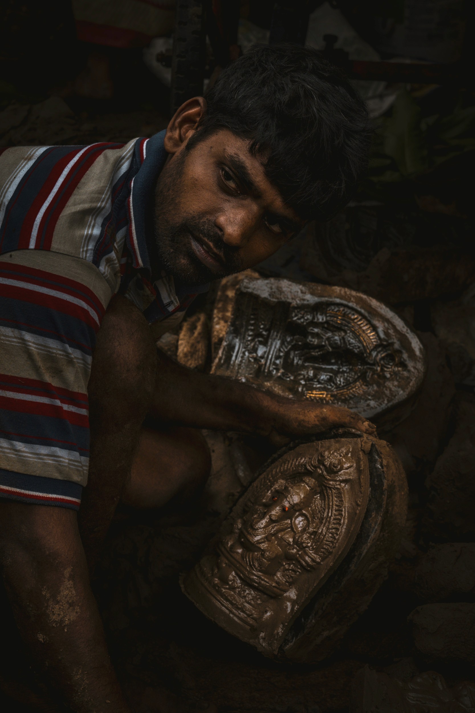 The Maker of Gods - Before the altar, there is the artist. In the quiet shadows, human hands shape the divine from common clay.