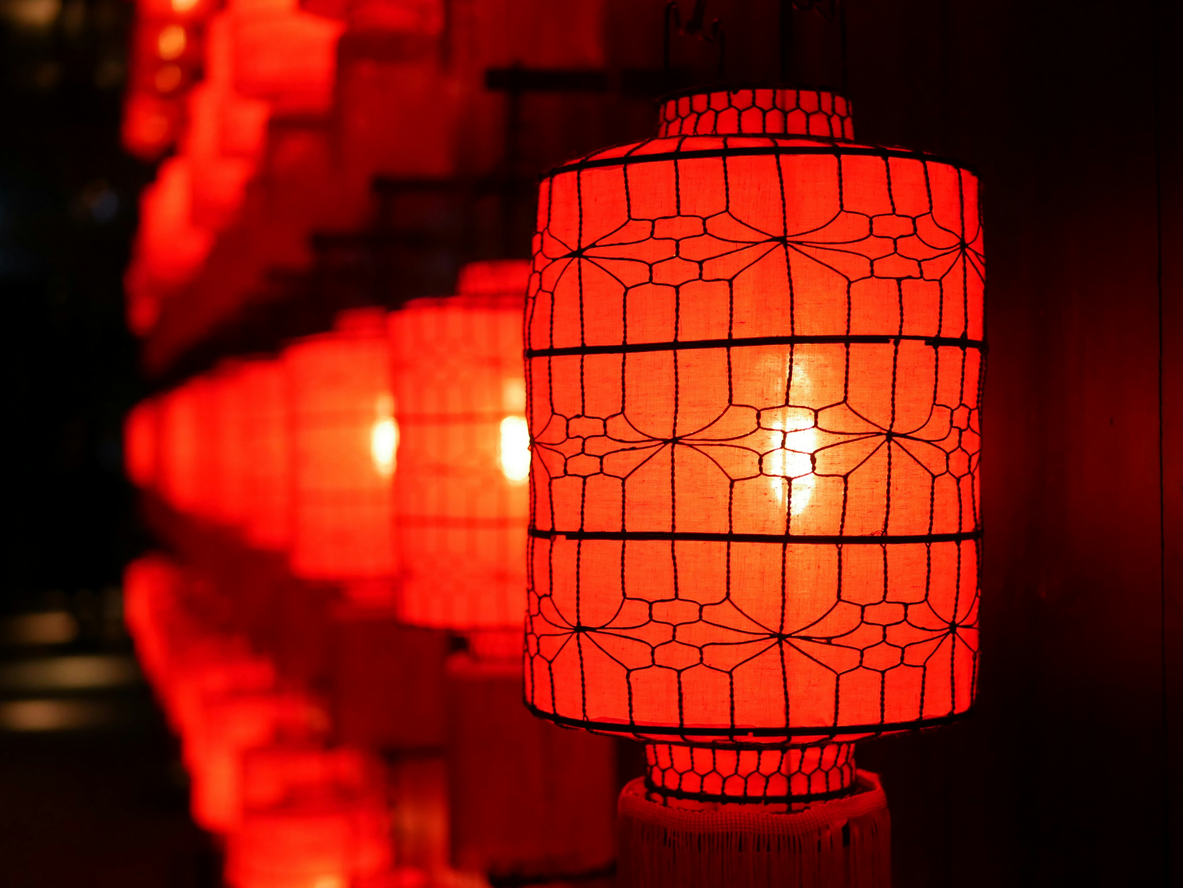 A row of glowing red paper lanterns