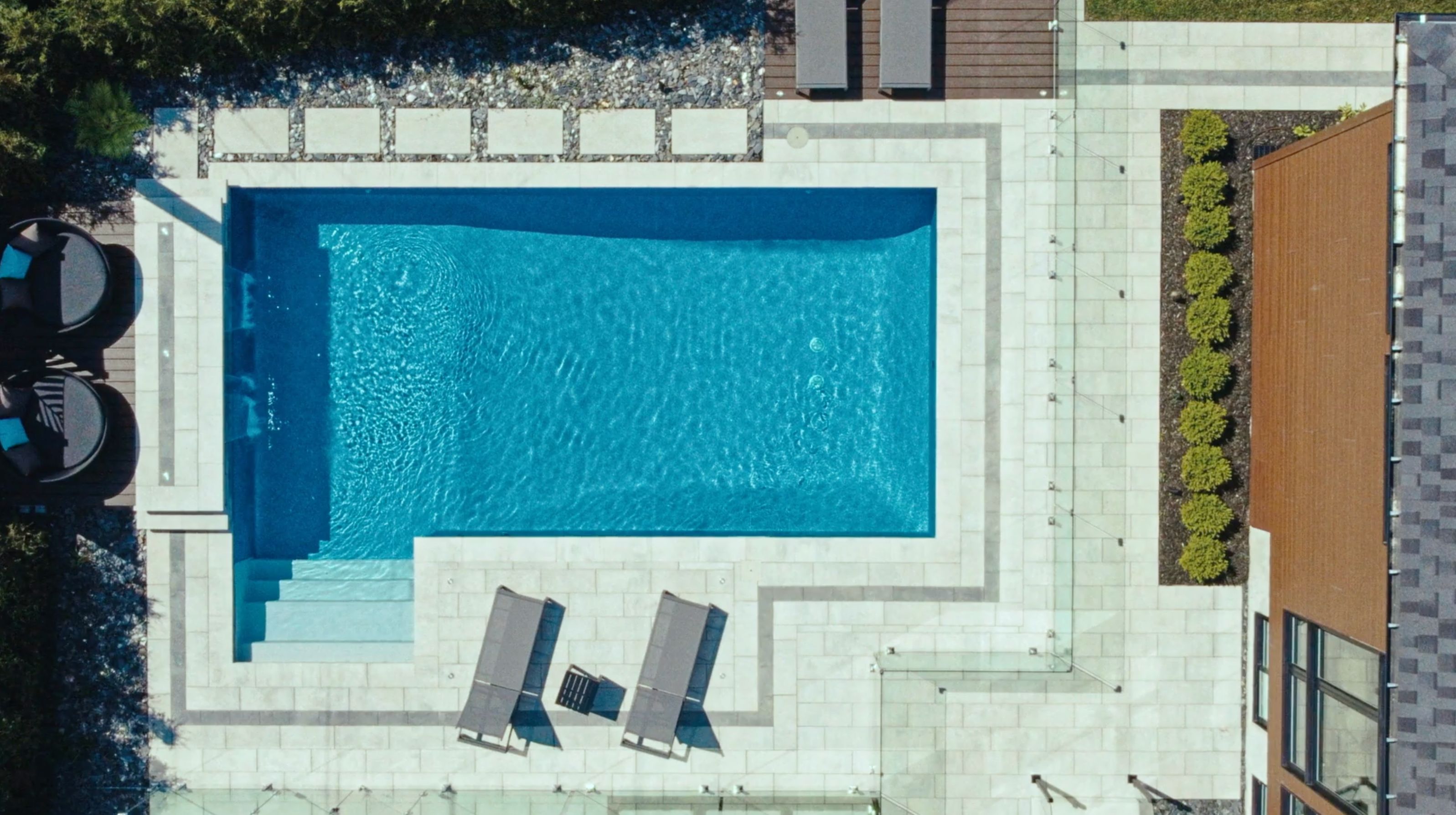 Aerial view of an in-ground pool in the backyard of a house