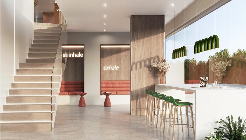 Contemporary lobby design with a tree centerpiece and comfortable chairs for guests to relax.