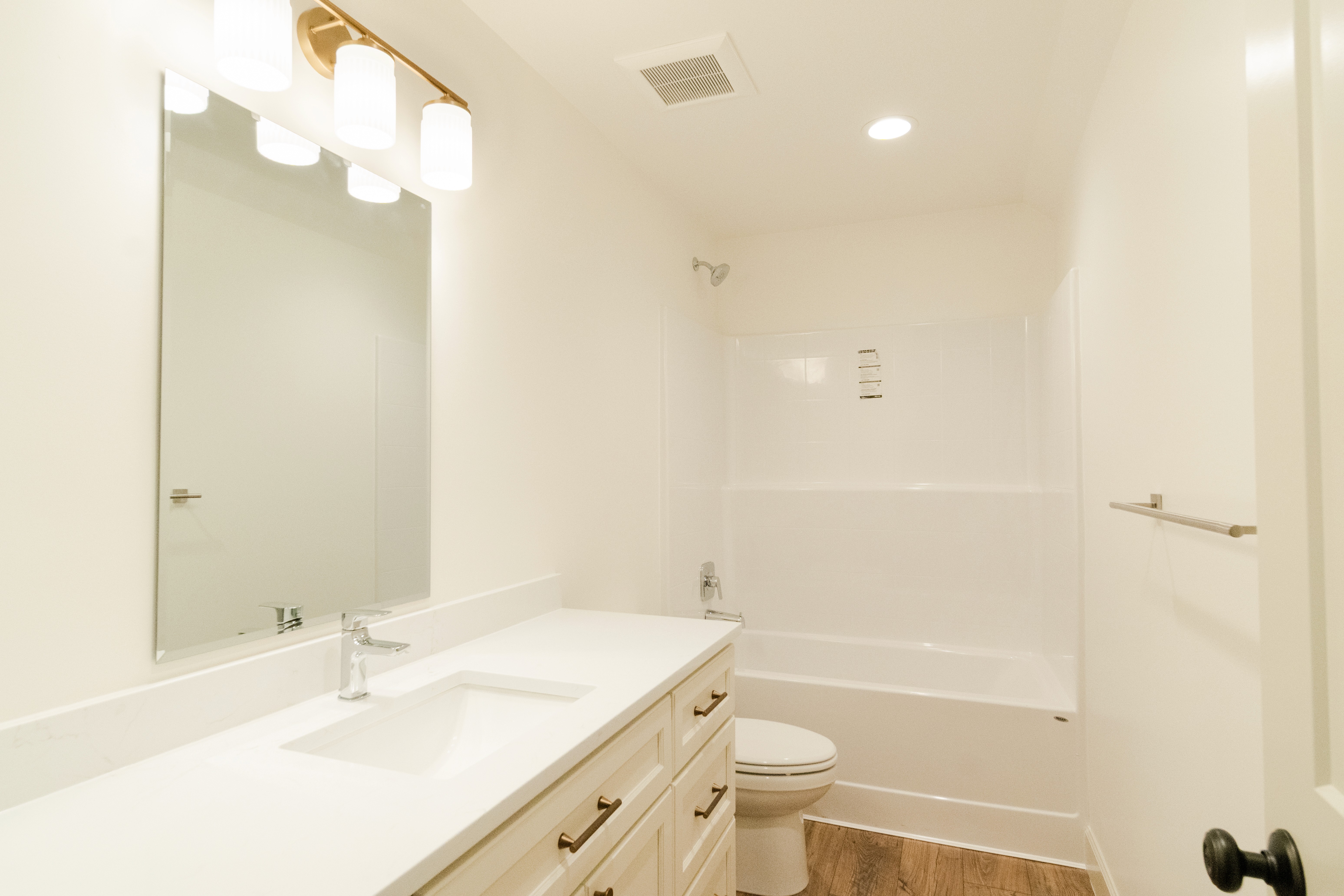 Upstairs bathroom with one sink vanity, toilet, and a shower bathtub combo.