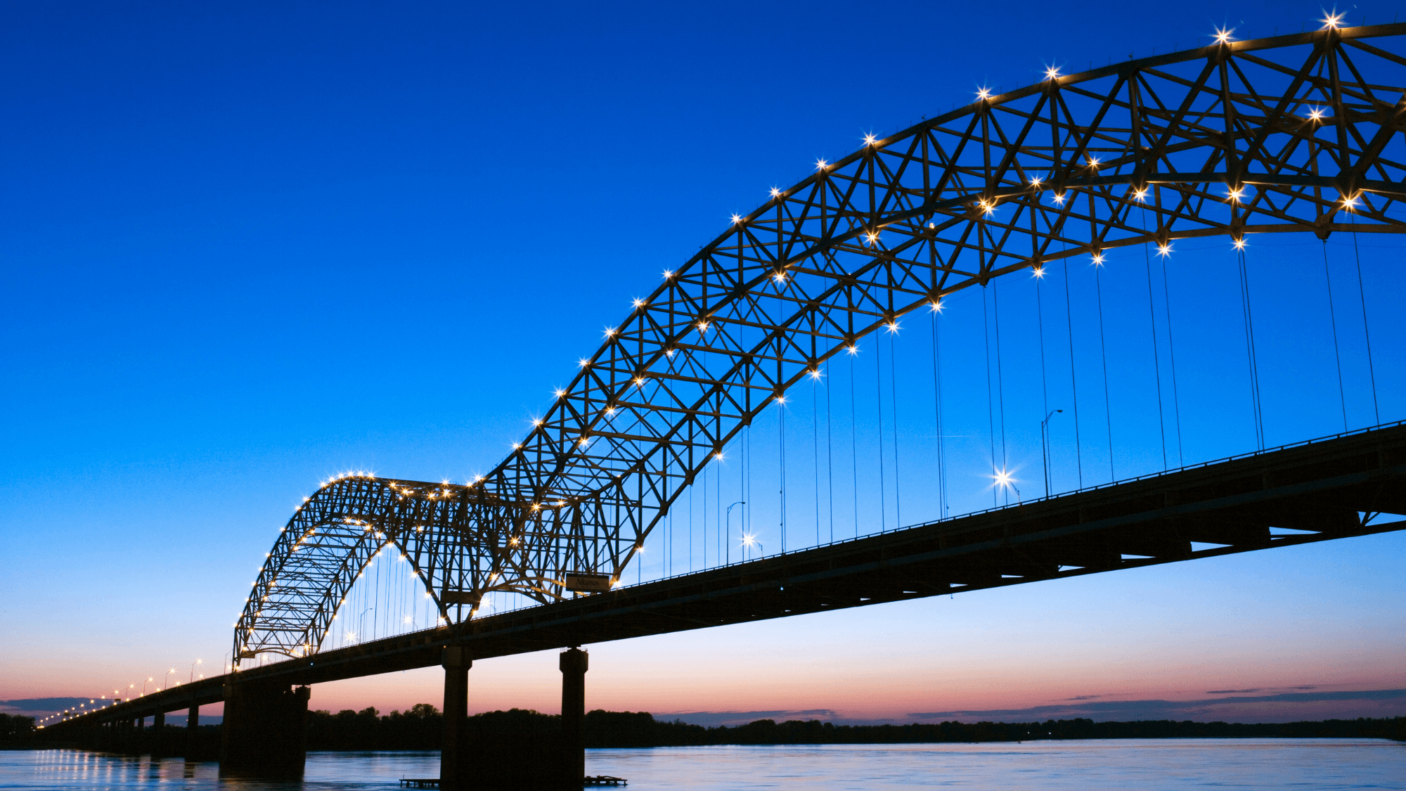 Portrait of a person in a pink sweater against a light background