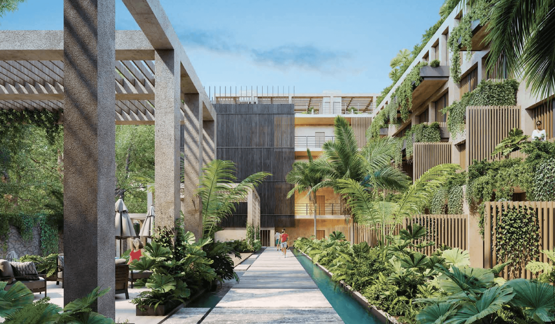A smiling woman with her arms crossed, standing against a dark green background. She has long, dark hair.